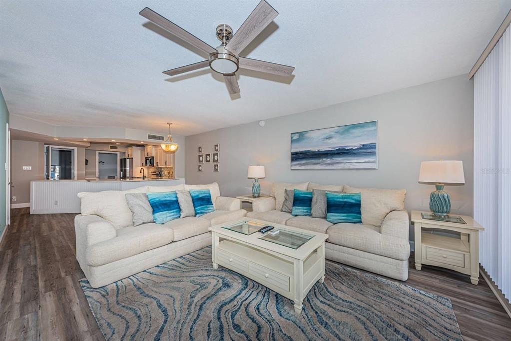 A living room features two beige sofas, a coffee table, and a ceiling fan — 5151 ISLA KEY BOULEVARD S UNIT 220, ST PETERSBURG, FL