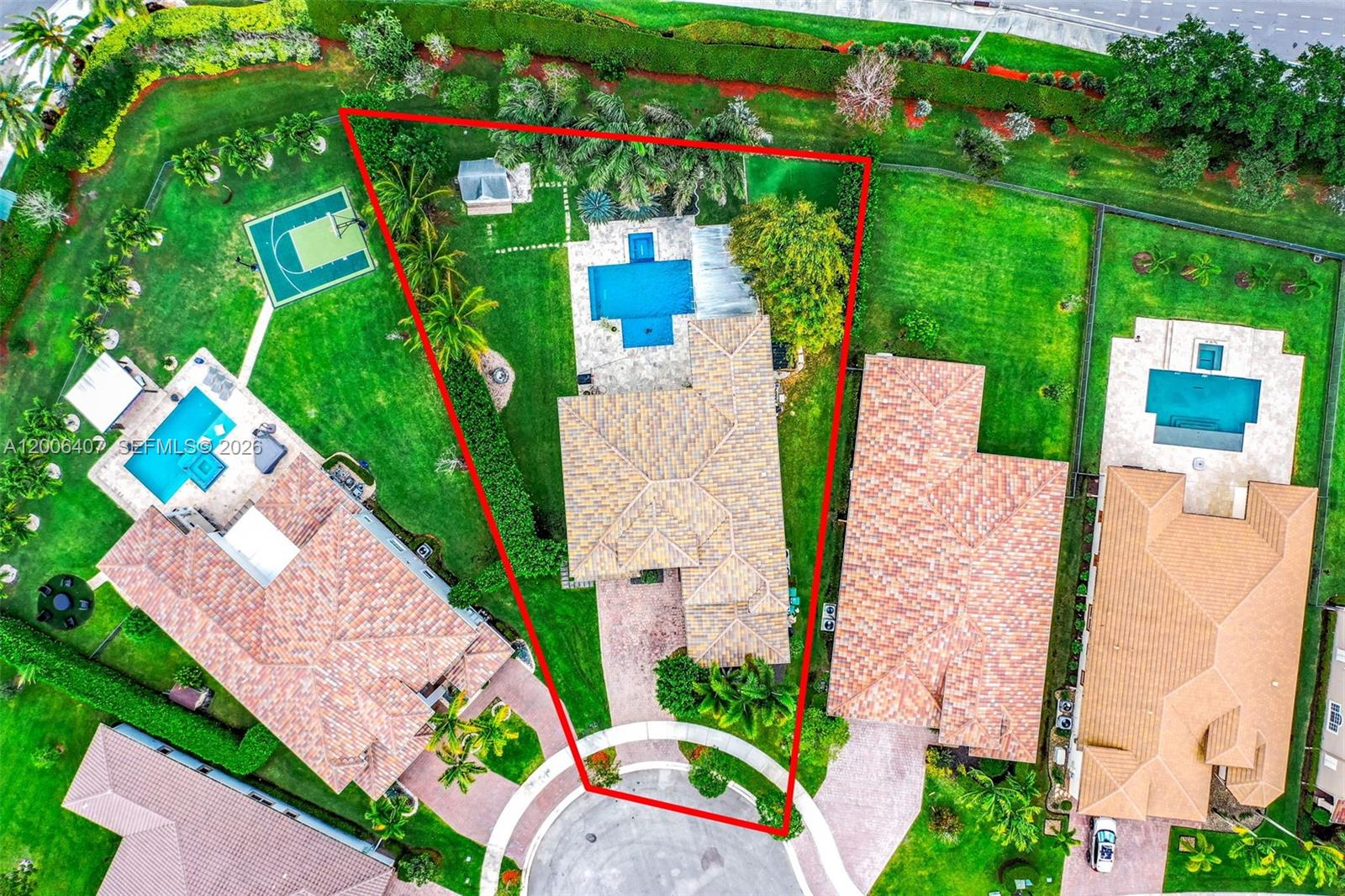 An aerial view shows a house with a pool and backyard within a cul-de-sac — 8766 Miralago Way, Parkland FL 33076, PARKLAND, FL