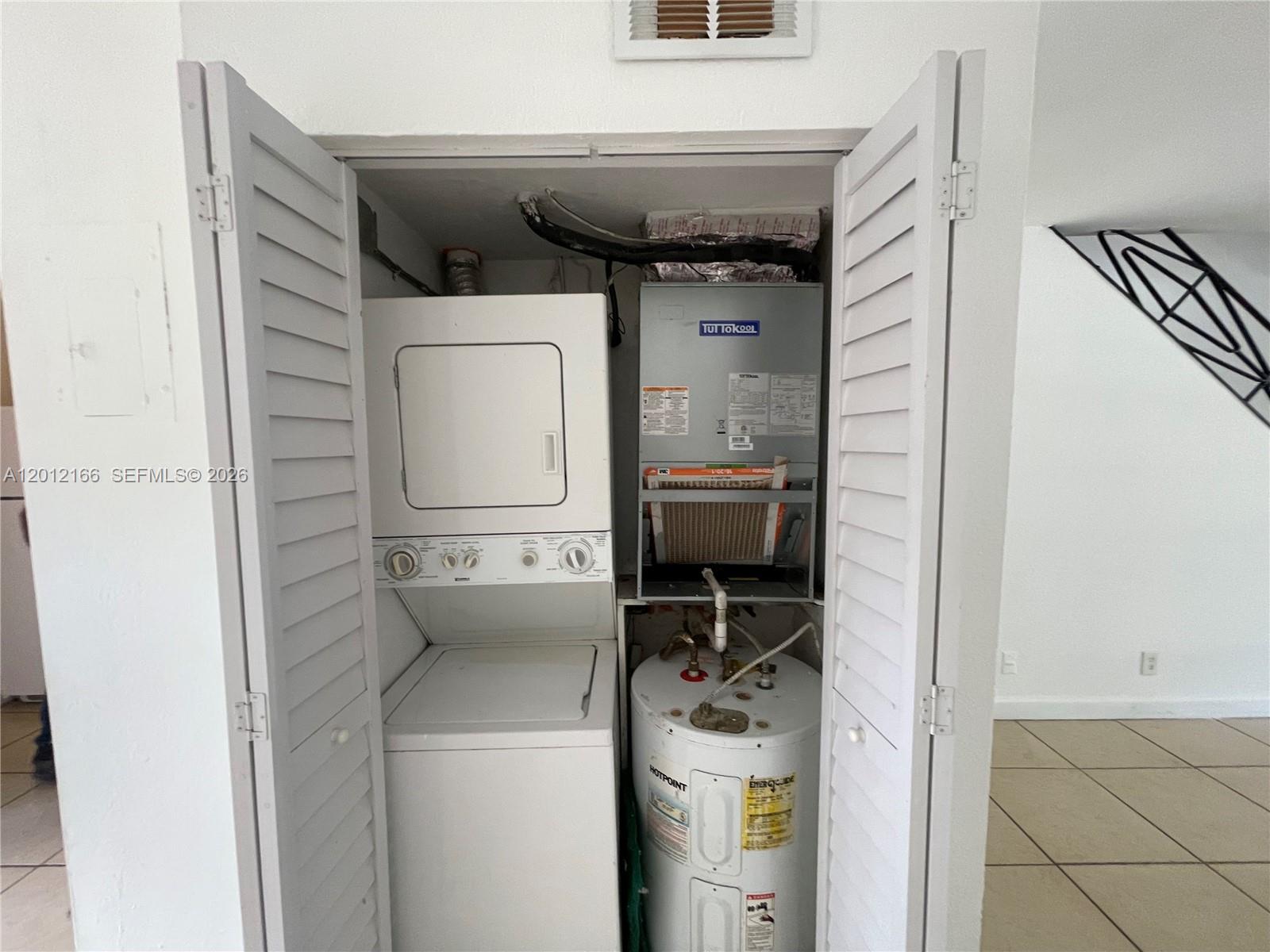 A closet contains a stacked washer-dryer unit, an HVAC air handler, and a water heater — 825 NW 46th Ave # 825, Plantation FL 33317, PLANTATION, FL