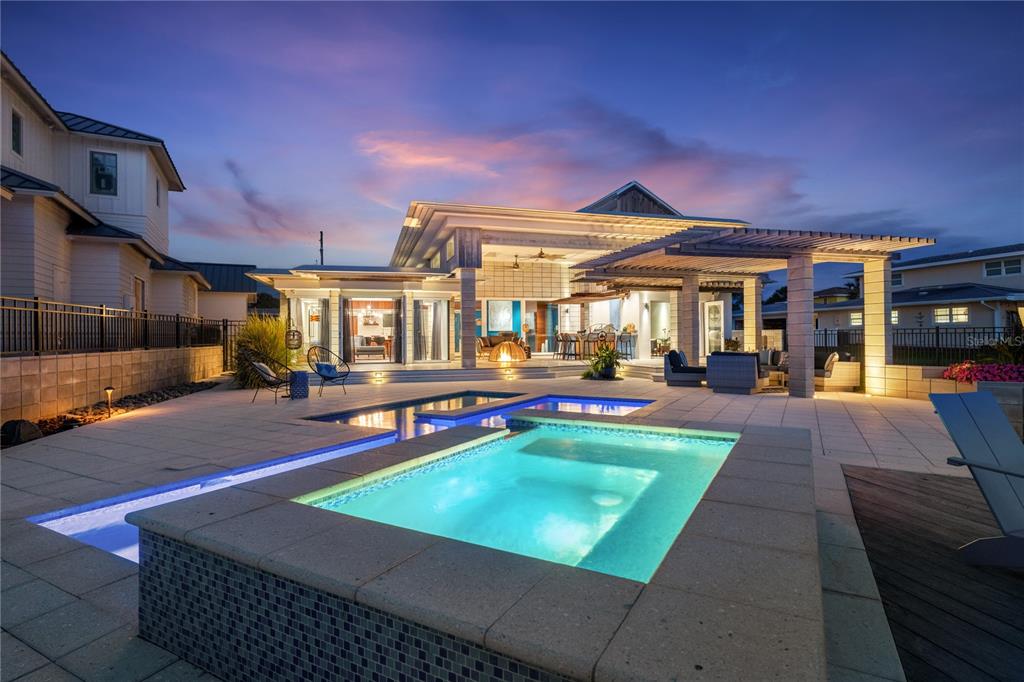 A modern house exterior features a swimming pool, a hot tub, and a covered patio — 1800 N INDIAN RIVER ROAD, NEW SMYRNA BEACH, FL