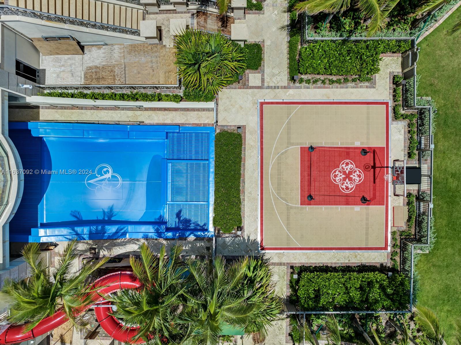 An aerial view shows a swimming pool with a cover, a basketball court, and a slide — 17901 Collins, Sunny Isles Beach FL 33160, SUNNY ISLES BEACH, FL