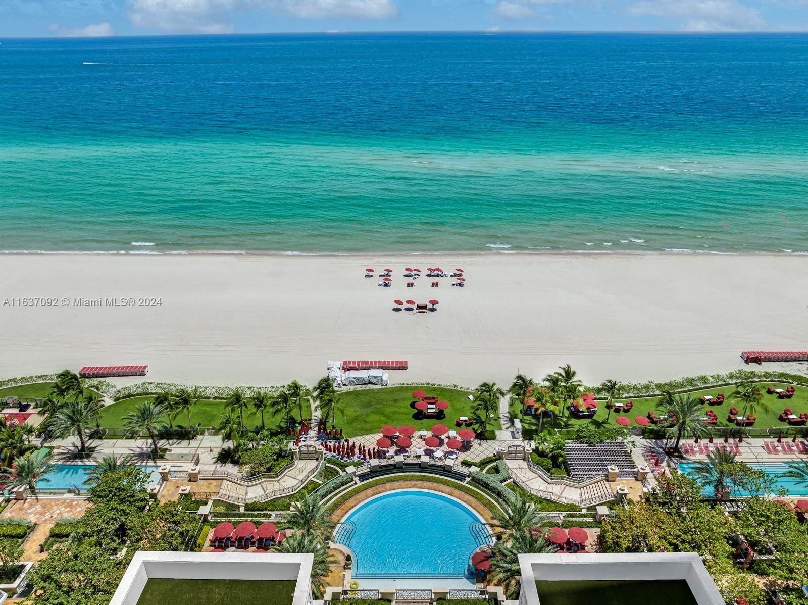 An aerial view shows a resort pool deck, sandy beach, and the ocean — 17901 Collins, Sunny Isles Beach FL 33160, SUNNY ISLES BEACH, FL