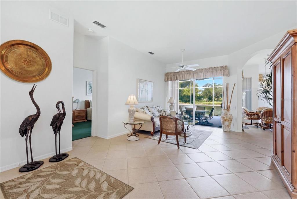 A dining area with a chandelier and a large entryway with double doors — 3175 VILLAGE LANE, PORT CHARLOTTE, FL