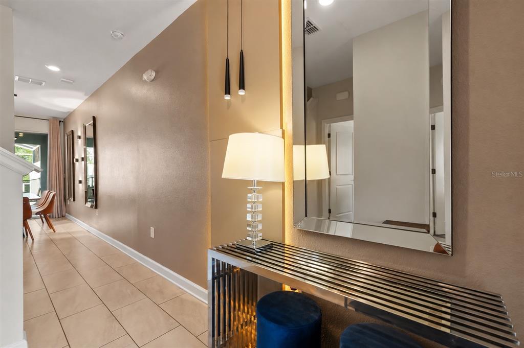A hallway features a metallic console table, a large mirror, and a modern table lamp — 374 OCEAN COURSE AVENUE, DAVENPORT, FL
