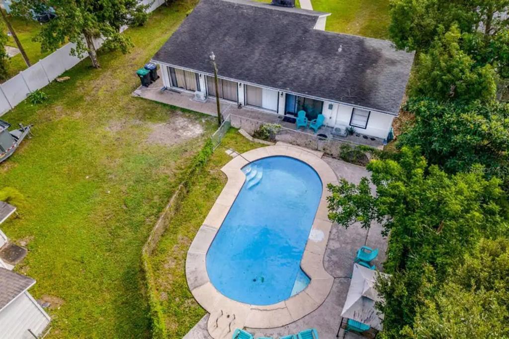 An aerial view of a house with a swimming pool and a large grassy yard — 2301 CARLTON DRIVE, ORLANDO, FL