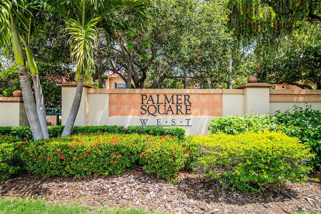A stone monument sign for Palmer Square West stands behind a manicured hedge and trees — 3663 SQUARE WEST LANE UNIT 12, SARASOTA, FL