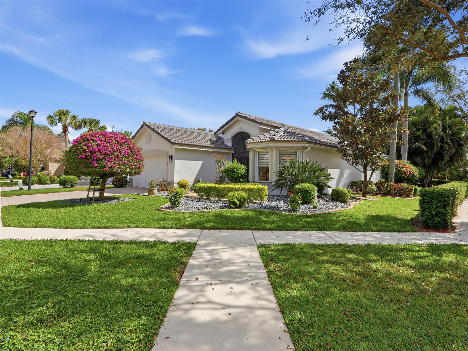 A single-story house with a tiled roof, landscaped front yard, and a paved walkway — 11184 Ihilani Way, Boynton Beach FL 33437, BOYNTON BEACH, FL
