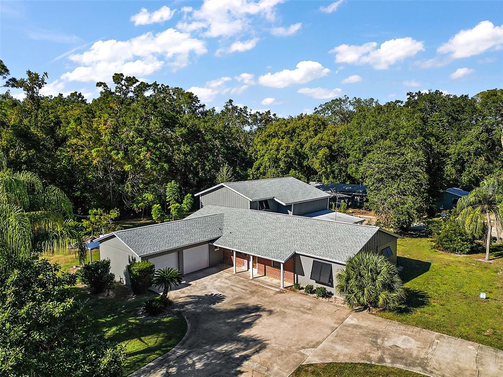 An aerial view of a two-story house with a gray roof and a concrete driveway — 1661 VOTAW ROAD, APOPKA, FL