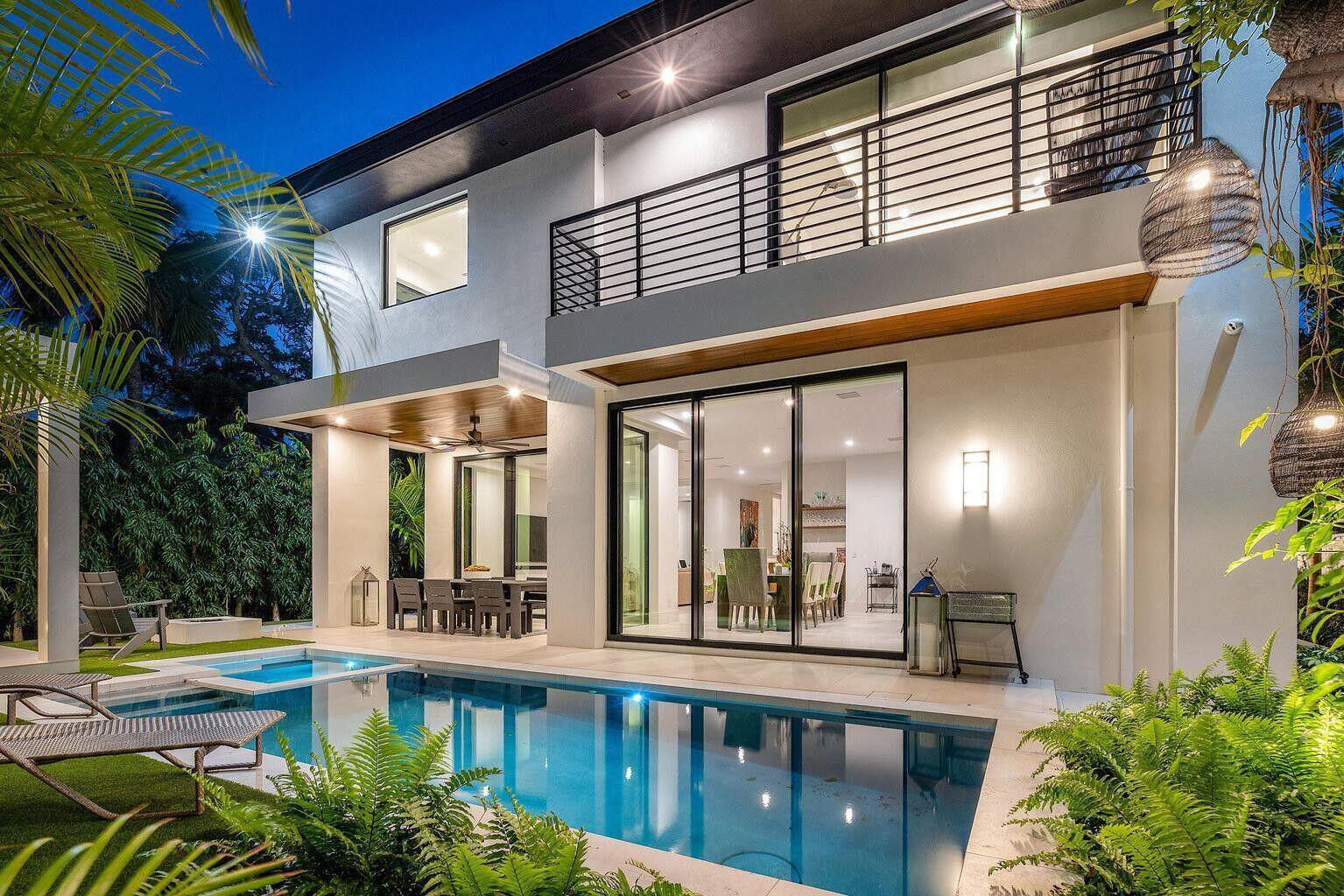 A two-story modern house with a swimming pool, patio, and balcony at twilight — 775 W Park Dr Drive W, Boca Raton FL 33432, BOCA RATON, FL
