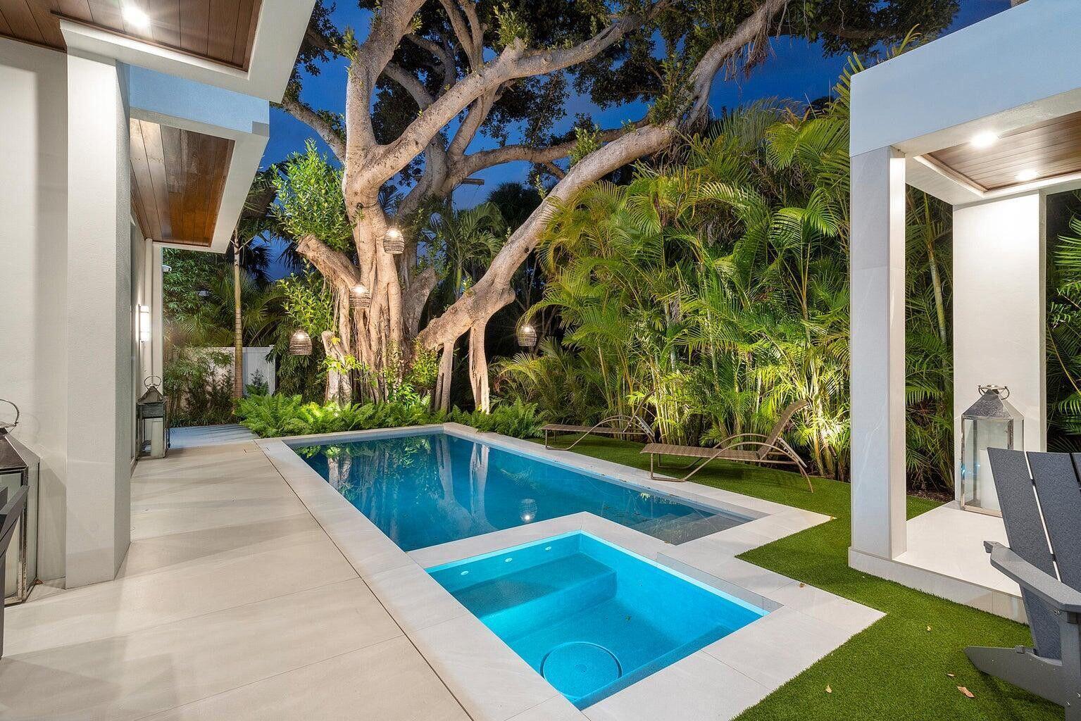 A modern backyard pool and spa area surrounded by lush tropical landscaping and large trees — 775 W Park Dr Drive W, Boca Raton FL 33432, BOCA RATON, FL