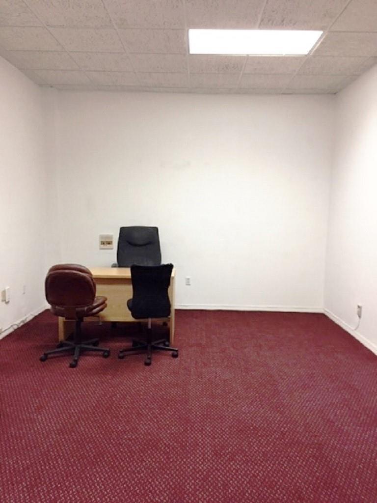 A small office room features a wooden desk, three chairs, and red patterned carpeting — 2012 Hollywood Bl # D, Hollywood FL 33020, HOLLYWOOD, FL