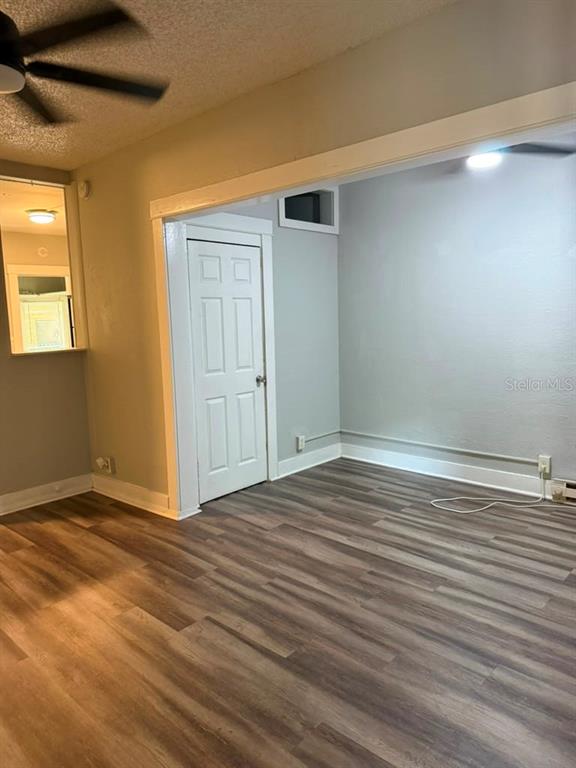An interior room features wood-look flooring, light gray walls, and a white interior door — 308 GROVE STREET N UNIT 102, ST PETERSBURG, FL