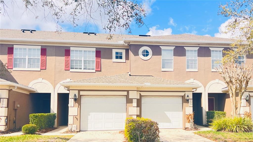 A sign for Victoria Pines sits behind a garden bed filled with colorful flowers — 3514 VICTORIA PINES DRIVE UNIT 148, ORLANDO, FL