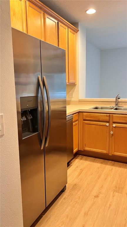 A kitchen features light wood cabinets, stainless steel appliances, and beige countertops — 3514 VICTORIA PINES DRIVE UNIT 148, ORLANDO, FL