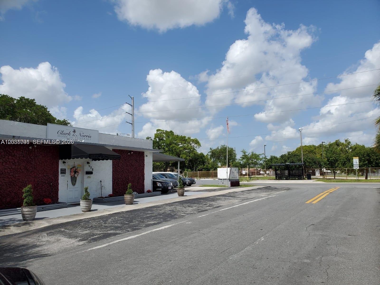 The exterior of a funeral home building features a red textured facade and parking area — 608 SW 12th Ave, Dania Beach FL 33004, DANIA BEACH, FL