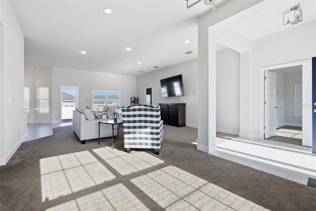 A single-story house with a blue front door, gray stucco exterior, and a concrete walkway — 9144 SE 47TH COURT ROAD, OCALA, FL