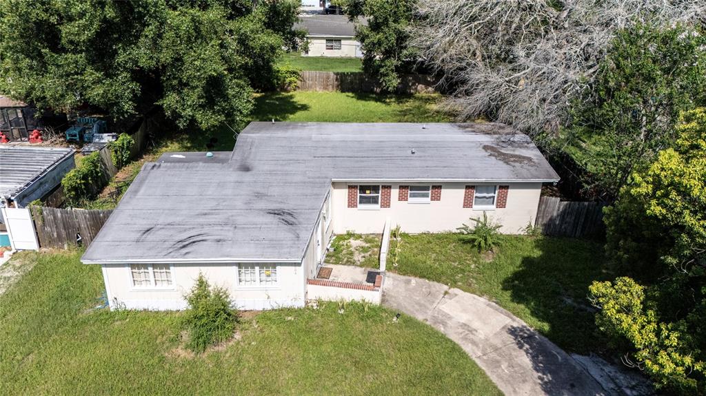 An aerial view shows a single-story house with a flat roof and a concrete driveway — 4604 ROBBINS AVENUE, ORLANDO, FL