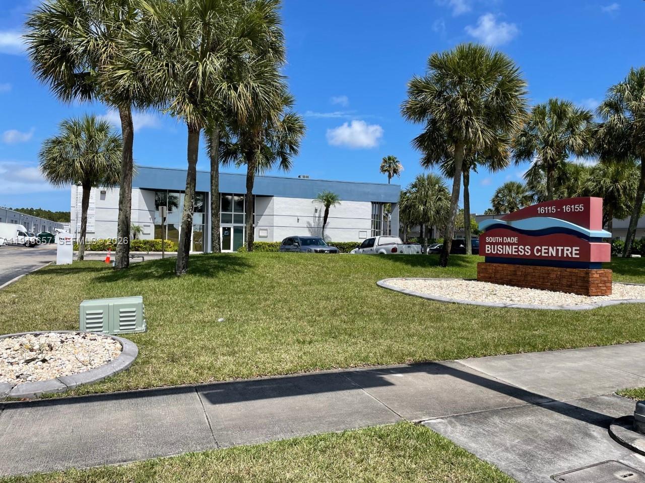 A sign for the South Dade Business Centre stands on a lawn before a building — 16155 SW 117th Ave # B2, Miami FL 33177, MIAMI, FL