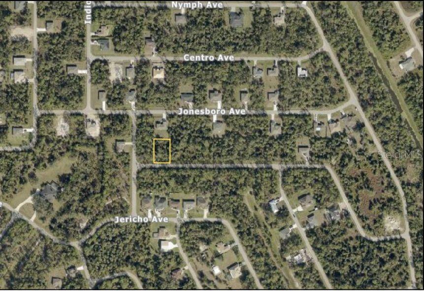 An aerial map view shows a highlighted vacant residential lot in a wooded neighborhood — MYRT ROAD, NORTH PORT, FL