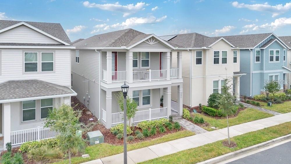 A two-story gray house with a front porch and a second-story balcony — 15026 SUMMER HARVEST STREET, WINTER GARDEN, FL