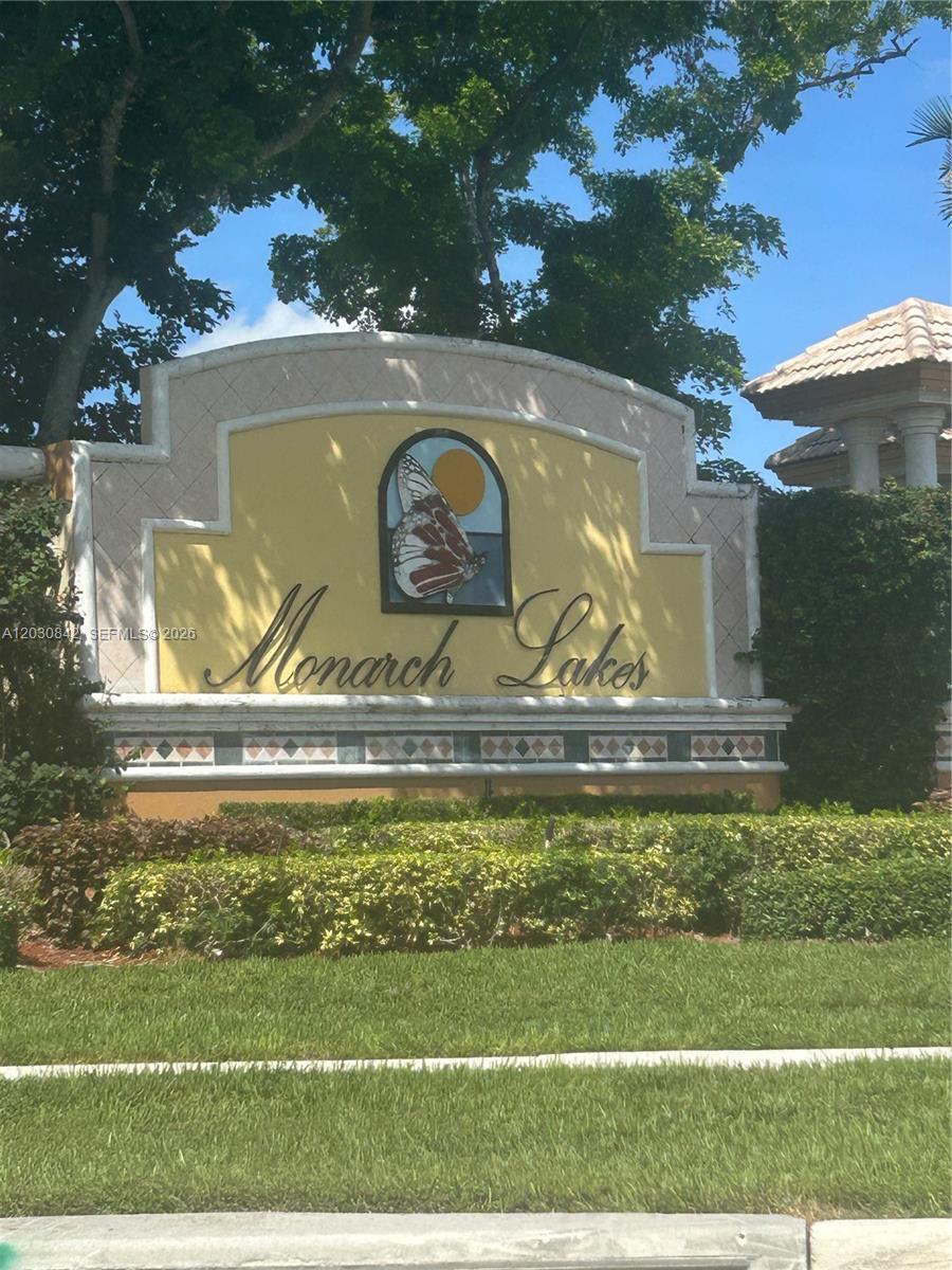 A decorative sign for Monarch Lakes stands in front of green landscaping and trees — 3073 SW 140th Ave # 3073, Miramar FL 33027, MIRAMAR, FL