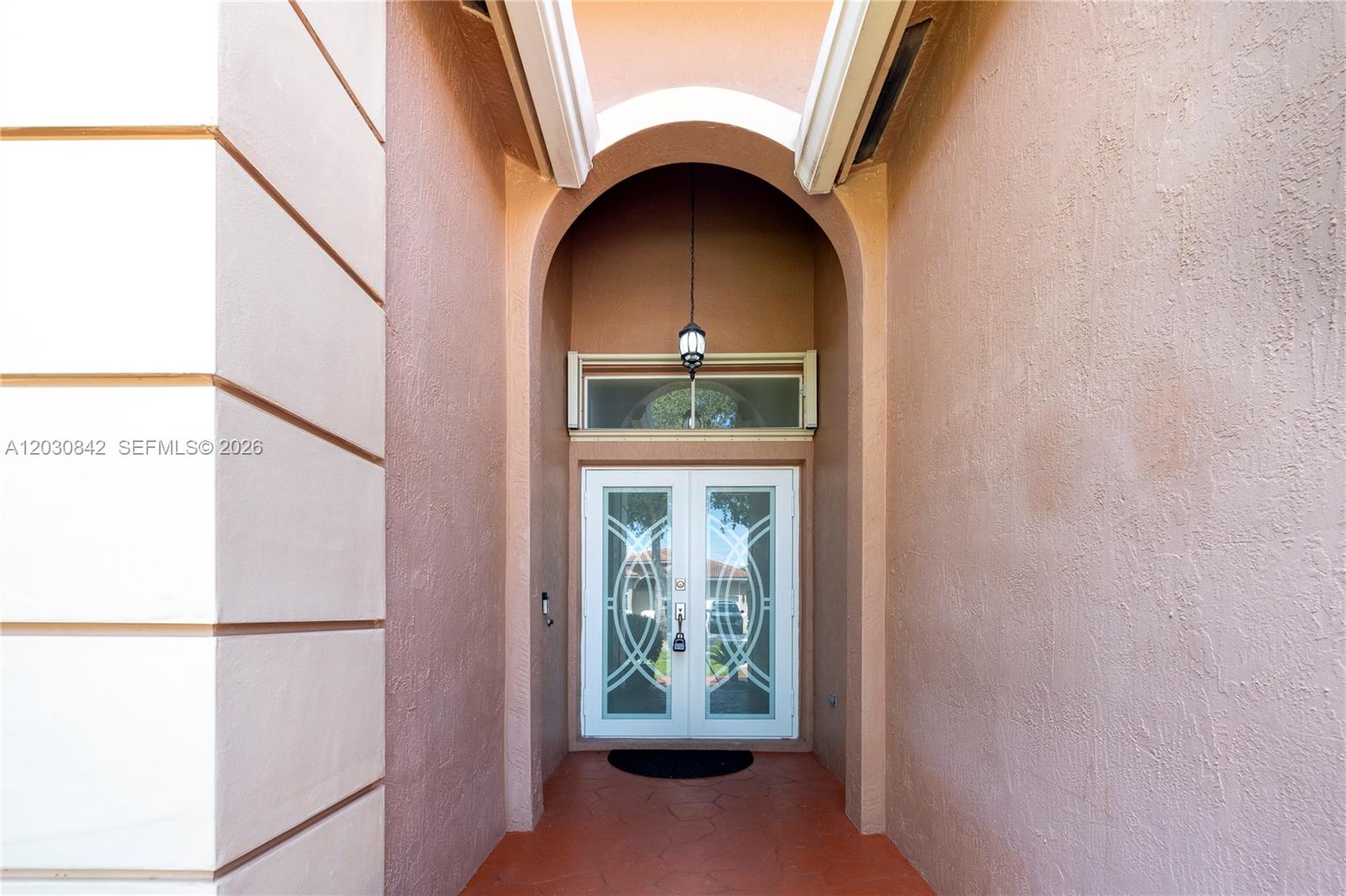A recessed entryway features a double glass door under an arched ceiling and pendant light — 3073 SW 140th Ave # 3073, Miramar FL 33027, MIRAMAR, FL