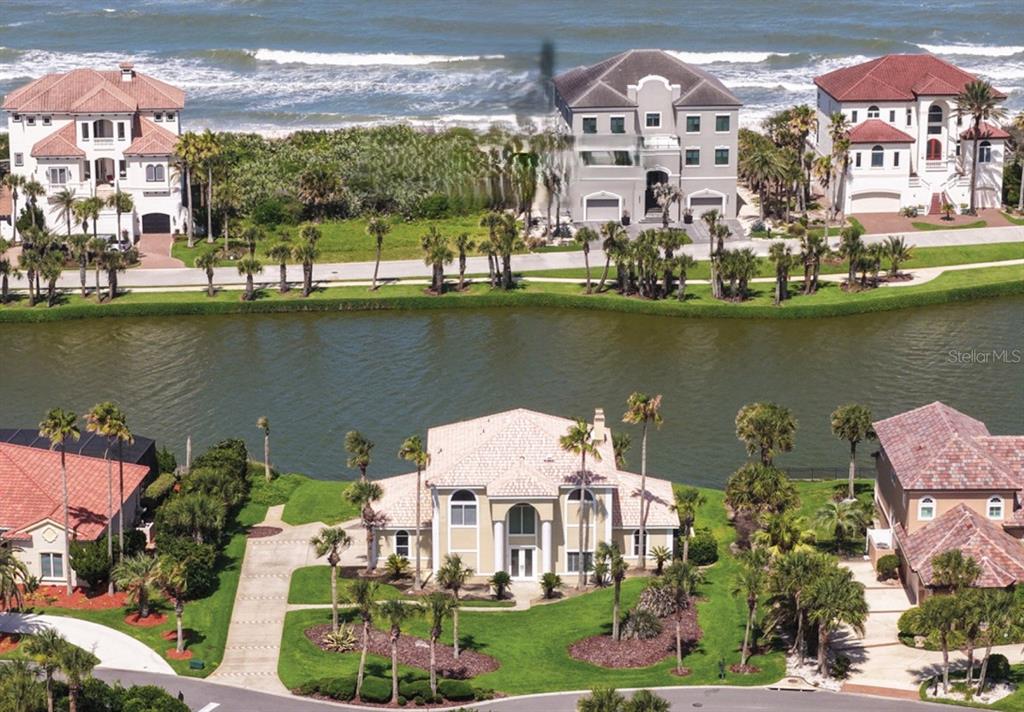 An aerial view shows several large houses situated between a canal and the ocean — 1 SAN GABRIEL LANE, PALM COAST, FL