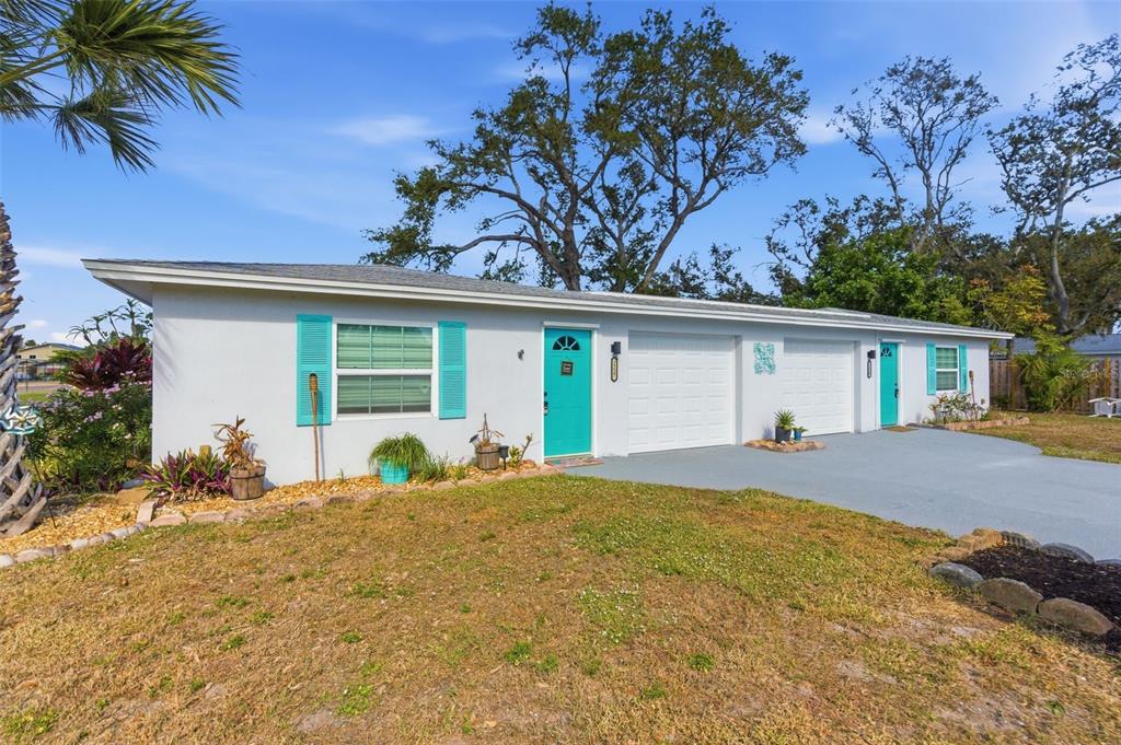 A single-story house with a light gray exterior, turquoise doors, and two attached garages — 2227-2229 MONTCLAIR DRIVE UNIT 1&2, SARASOTA, FL