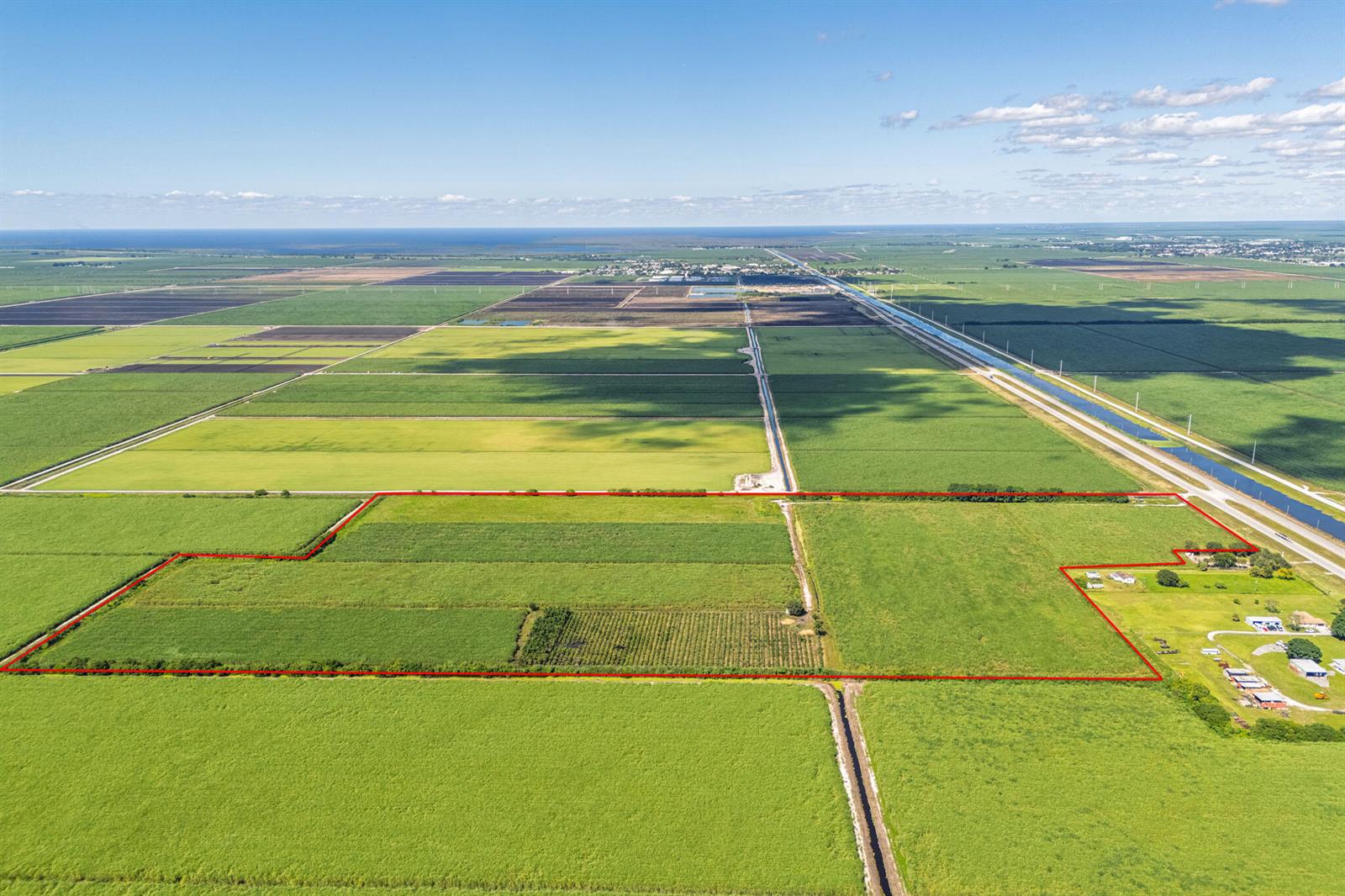 An aerial view shows a large, rectangular plot of farmland outlined in red — 0 Highway 27, South Bay FL 33493, SOUTH BAY, FL