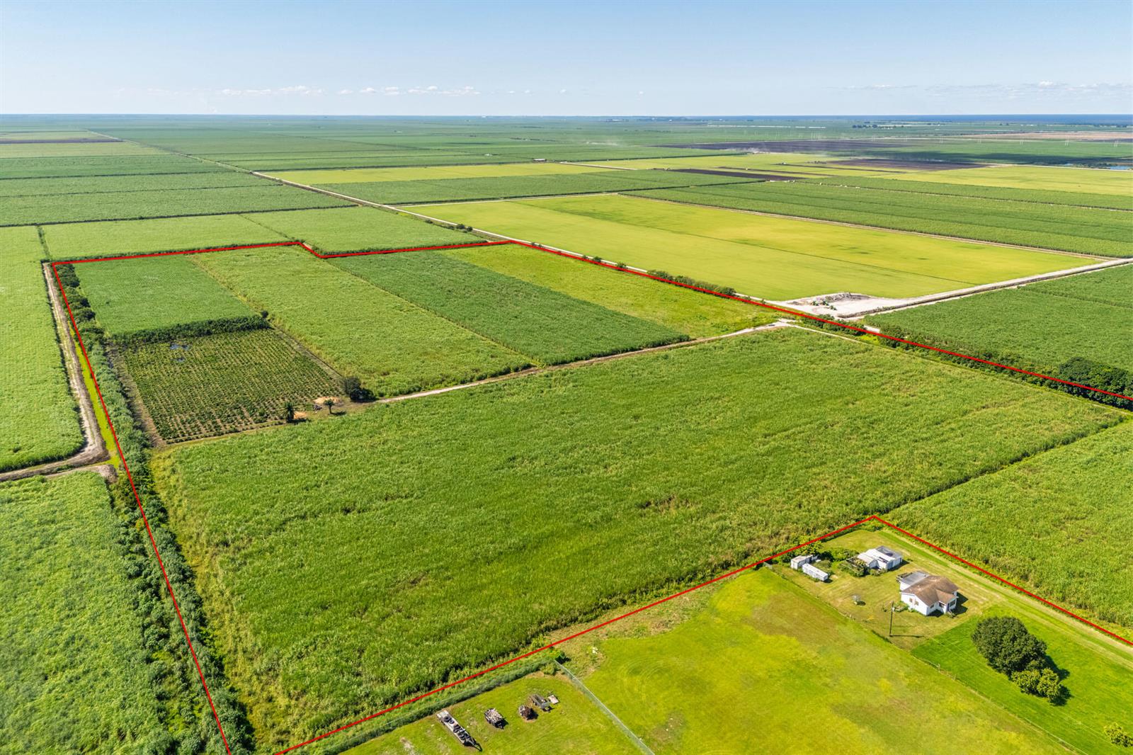 An aerial view shows a large, rectangular agricultural field outlined in red near a house — 0 Highway 27, South Bay FL 33493, SOUTH BAY, FL