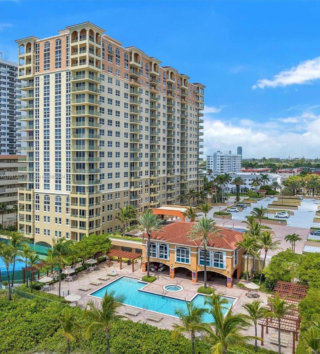 An aerial view of a tall residential building with a swimming pool and parking lot — 2080 S Ocean Dr # 1607, Hallandale Beach FL 33009, HALLANDALE BEACH, FL
