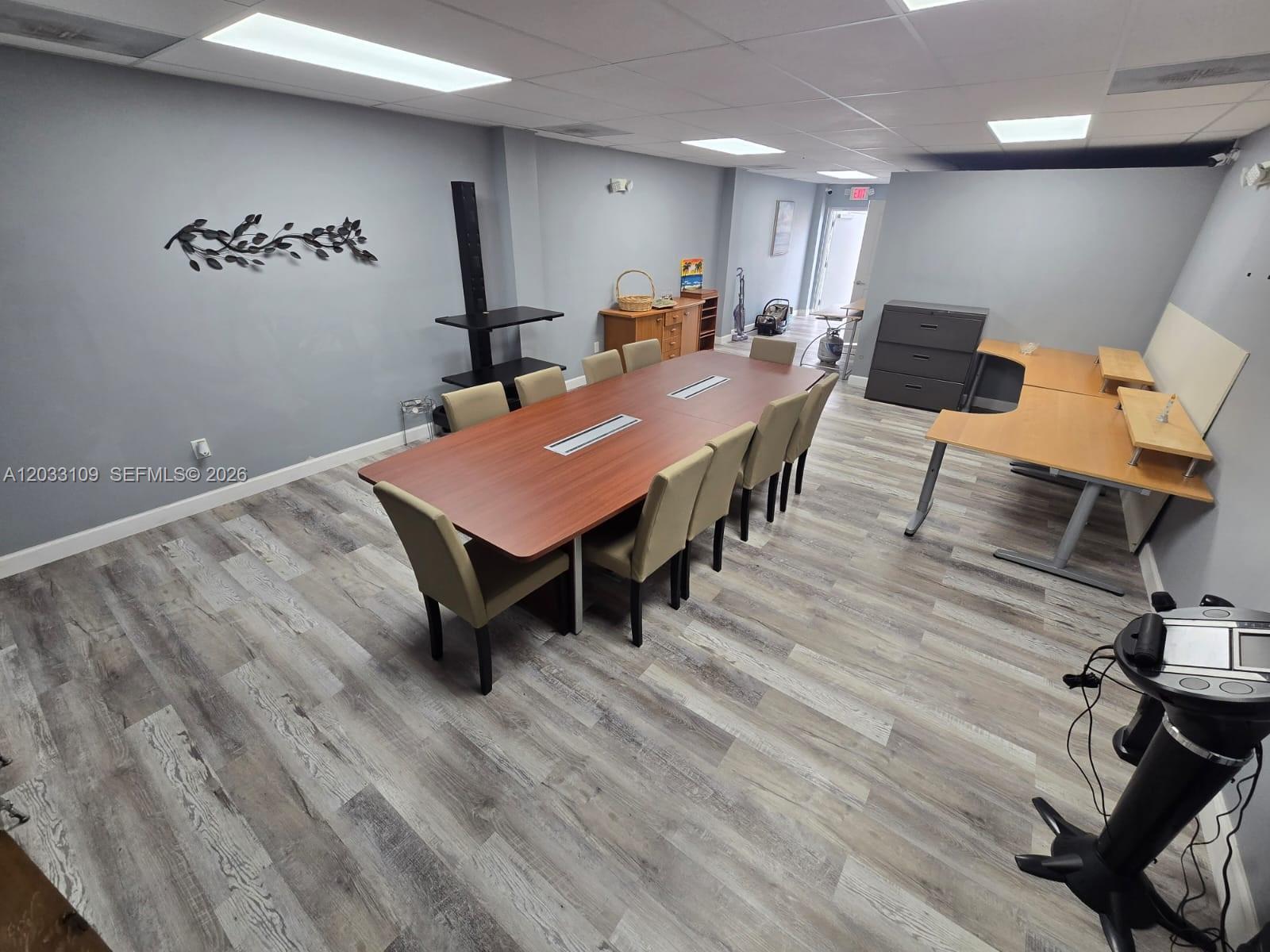 A conference room features a long wooden table, beige chairs, and light-colored wood-look flooring — 535 N State Road 7, Margate FL 33063, MARGATE, FL