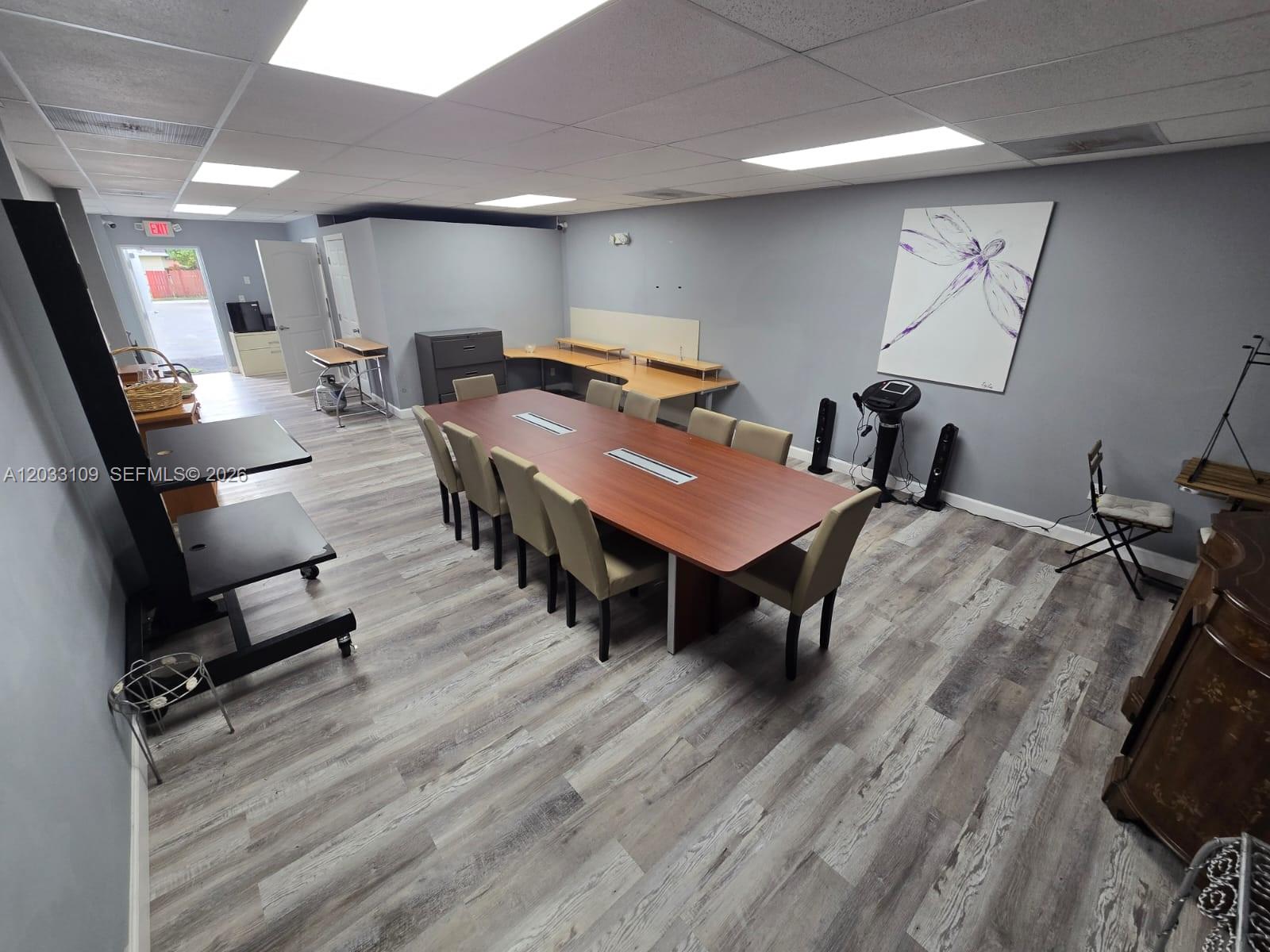A conference room features a long wooden table, gray walls, and wood-look flooring — 535 N State Road 7, Margate FL 33063, MARGATE, FL