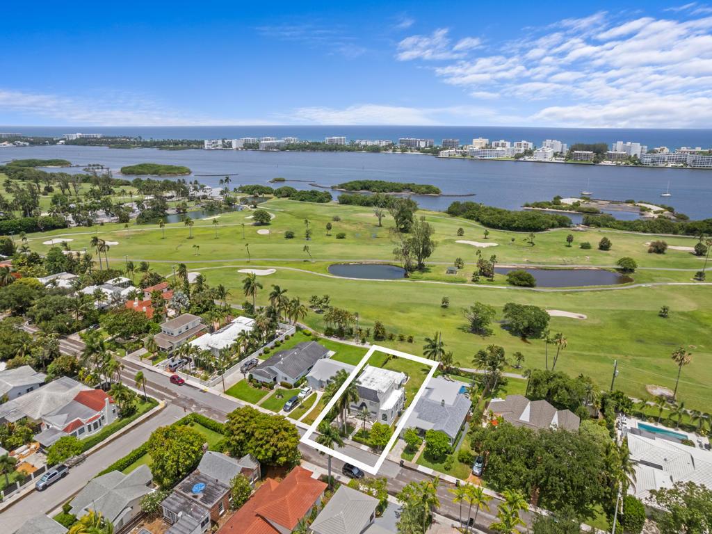 An aerial view shows a white house outlined in white, situated beside a golf course — 422 N Lakeside Drive, FL 33460, FL