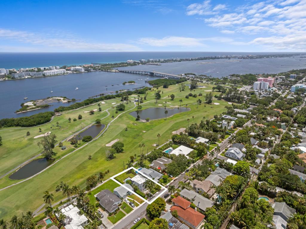 An aerial view shows a residential property highlighted in white, bordering a golf course and water — 422 N Lakeside Drive, FL 33460, FL