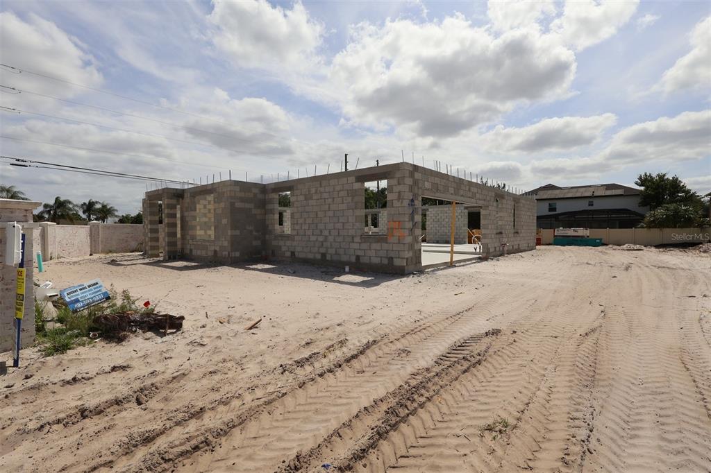 The exterior of a two-story house under construction features concrete block walls and Tyvek wrap — 2568 HAWKS OVERLOOK, OVIEDO, FL