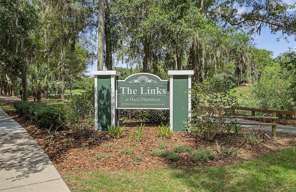 A green and white sign for The Links at Haile Plantation stands outdoors near trees — 10000 SW 52ND AVENUE UNIT AA-159, GAINESVILLE, FL