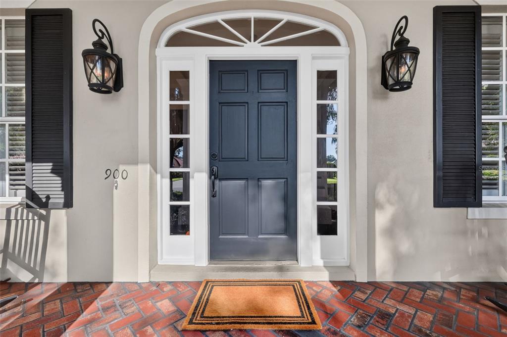 A front entrance features a dark blue door with sidelights and brick flooring — 900 BRIGHTWATER CIRCLE, MAITLAND, FL