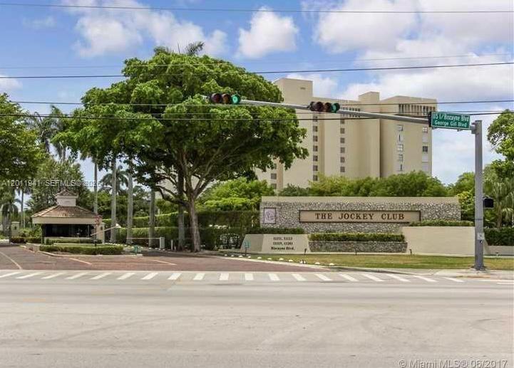 The exterior view shows the entrance sign and guardhouse for The Jockey Club residential complex — 11111 Biscayne Blvd # 2H, Miami FL 33181, MIAMI, FL