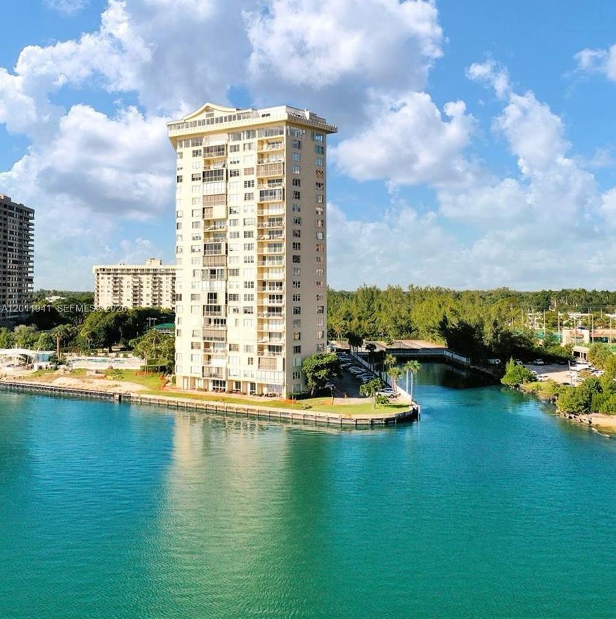 An aerial view of a tall residential building situated on a waterfront peninsula — 11111 Biscayne Blvd # 2H, Miami FL 33181, MIAMI, FL