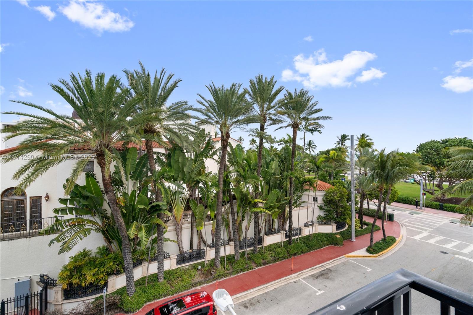 An exterior view shows a white building with palm trees and a red sidewalk — 1060 Ocean Dr # D307, Miami Beach FL 33139, MIAMI BEACH, FL