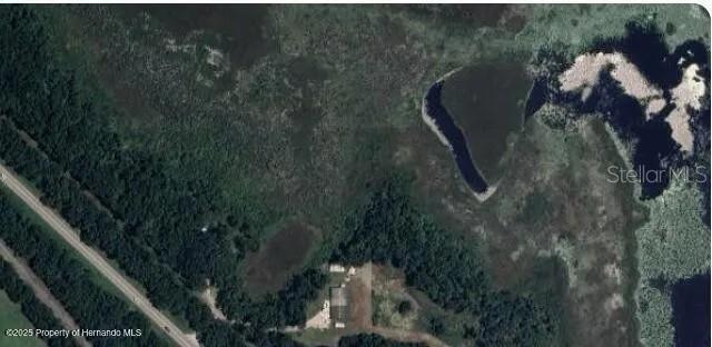 This aerial view shows a building situated next to a road and a large wetland — 0 PONCE DE LEON BOULEVARD, BROOKSVILLE, FL
