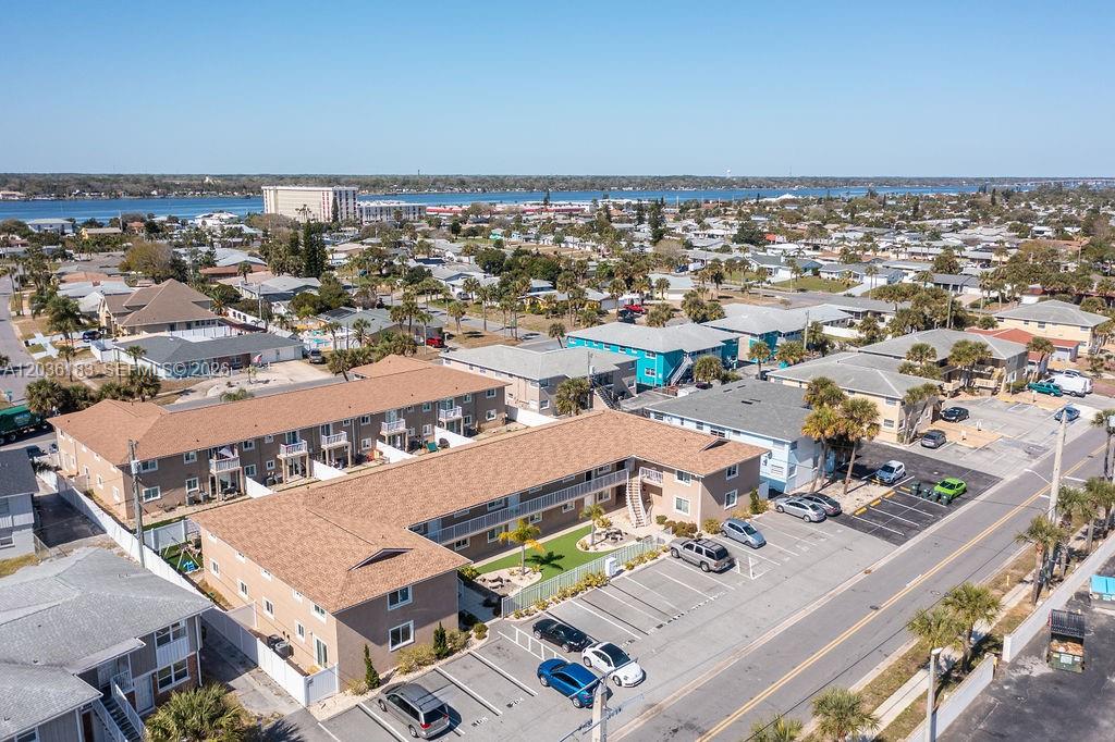 An aerial view shows a multi-story apartment complex with a parking lot and surrounding neighborhood — 2550 Tulane Ave # 101, Daytona FL 32118, DAYTONA, FL