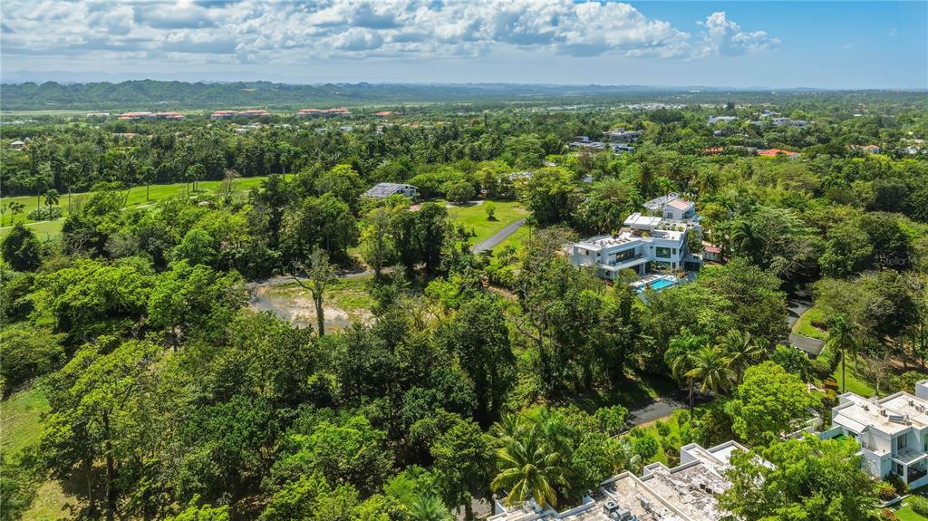 An aerial view shows a modern white house with a pool surrounded by lush greenery — Lot-17 VILLA DORADO ESTATES, DORADO, PR