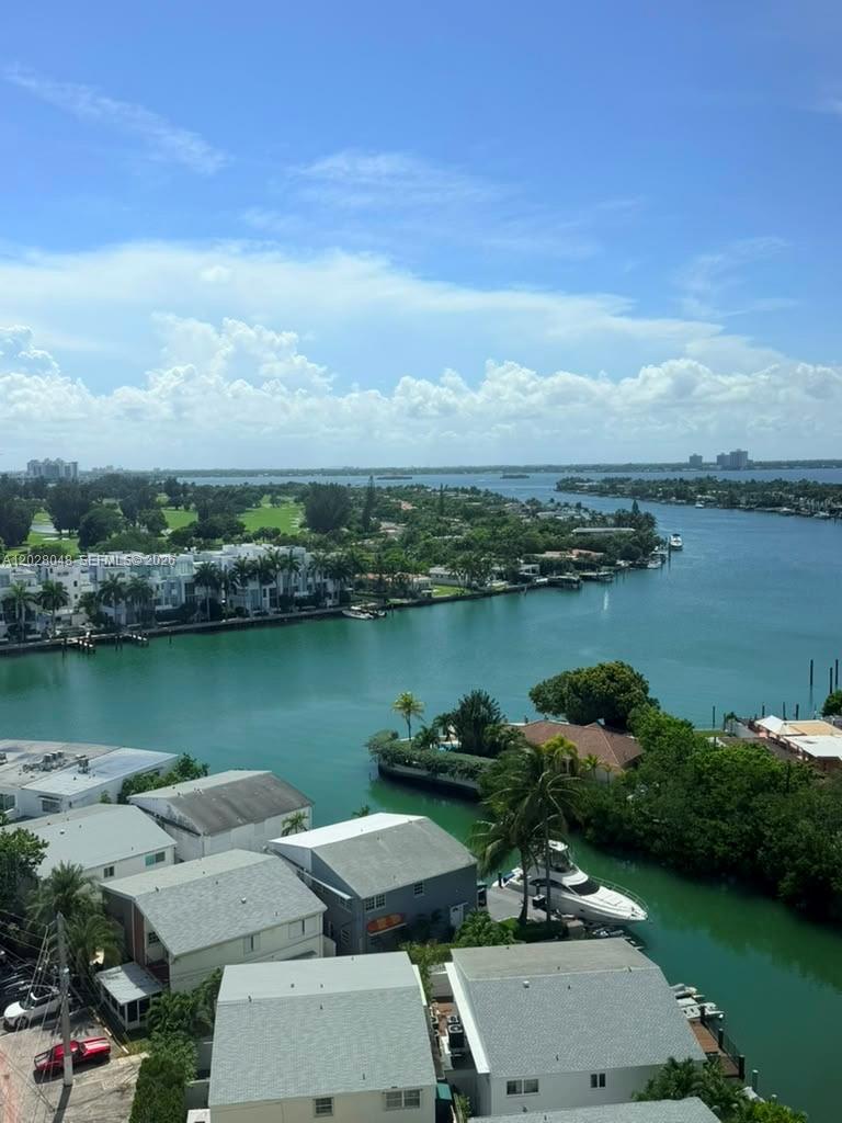 An elevated view of a waterfront residential area with houses, boats, and a golf course — 7441 Wayne Ave # 14D, Miami Beach FL 33141, MIAMI BEACH, FL