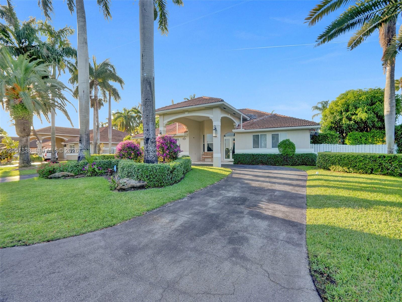 A single-story house with a tiled roof, arched entryway, and a paved driveway — 12401 SW 77th St # 12401, Miami FL 33183, MIAMI, FL