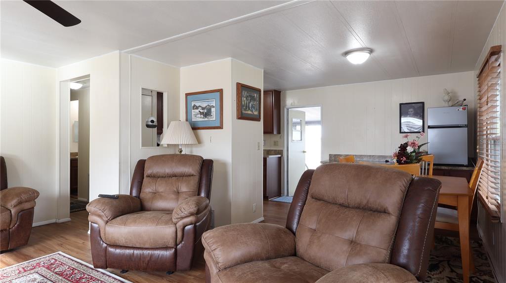 A blue-sided structure with a roll-up garage door and an attached metal-roofed carport — 1158 CR 439, LAKE PANASOFFKEE, FL