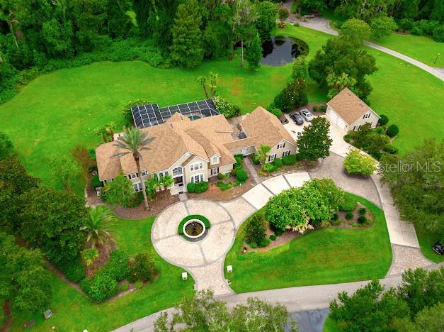 An aerial view shows a large house with a circular driveway, pool, and detached garage — 6823 NW 52ND LANE, GAINESVILLE, FL