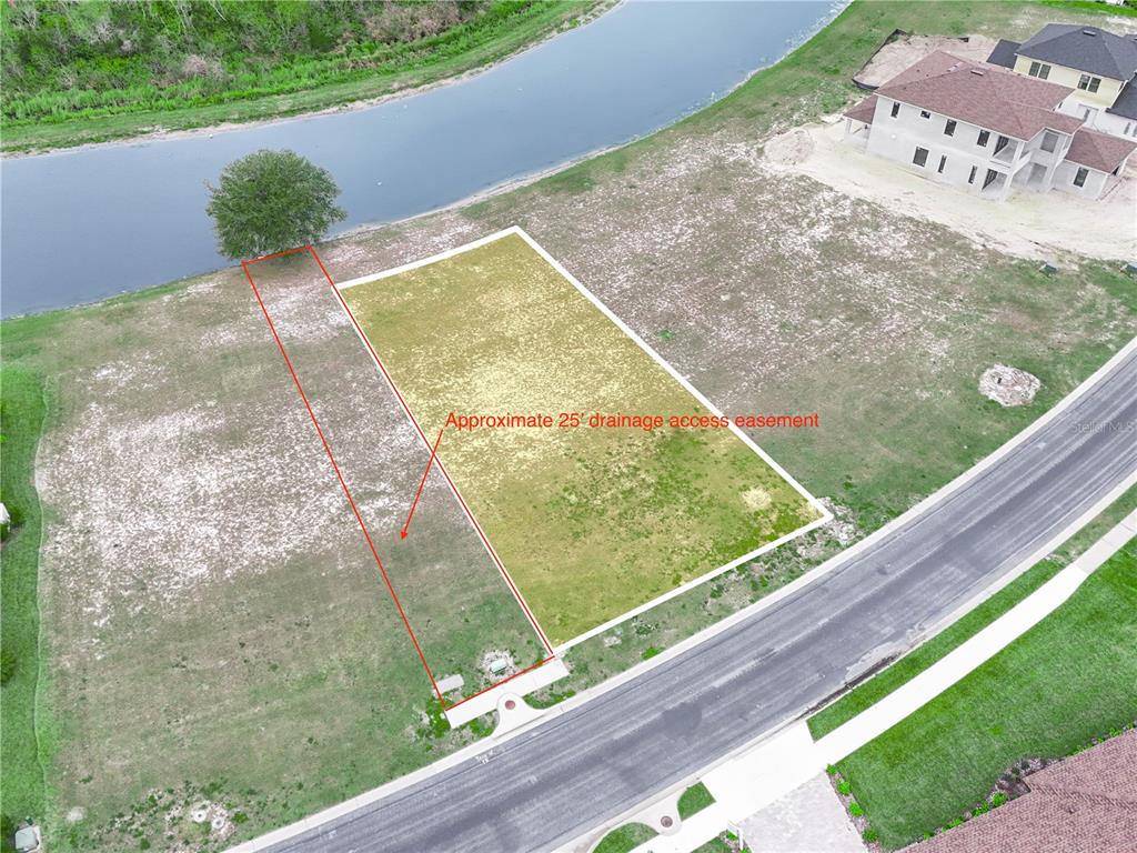 An aerial view shows a vacant residential lot with a marked drainage easement near water — 429 ADAMS VIEW LANE, AUBURNDALE, FL