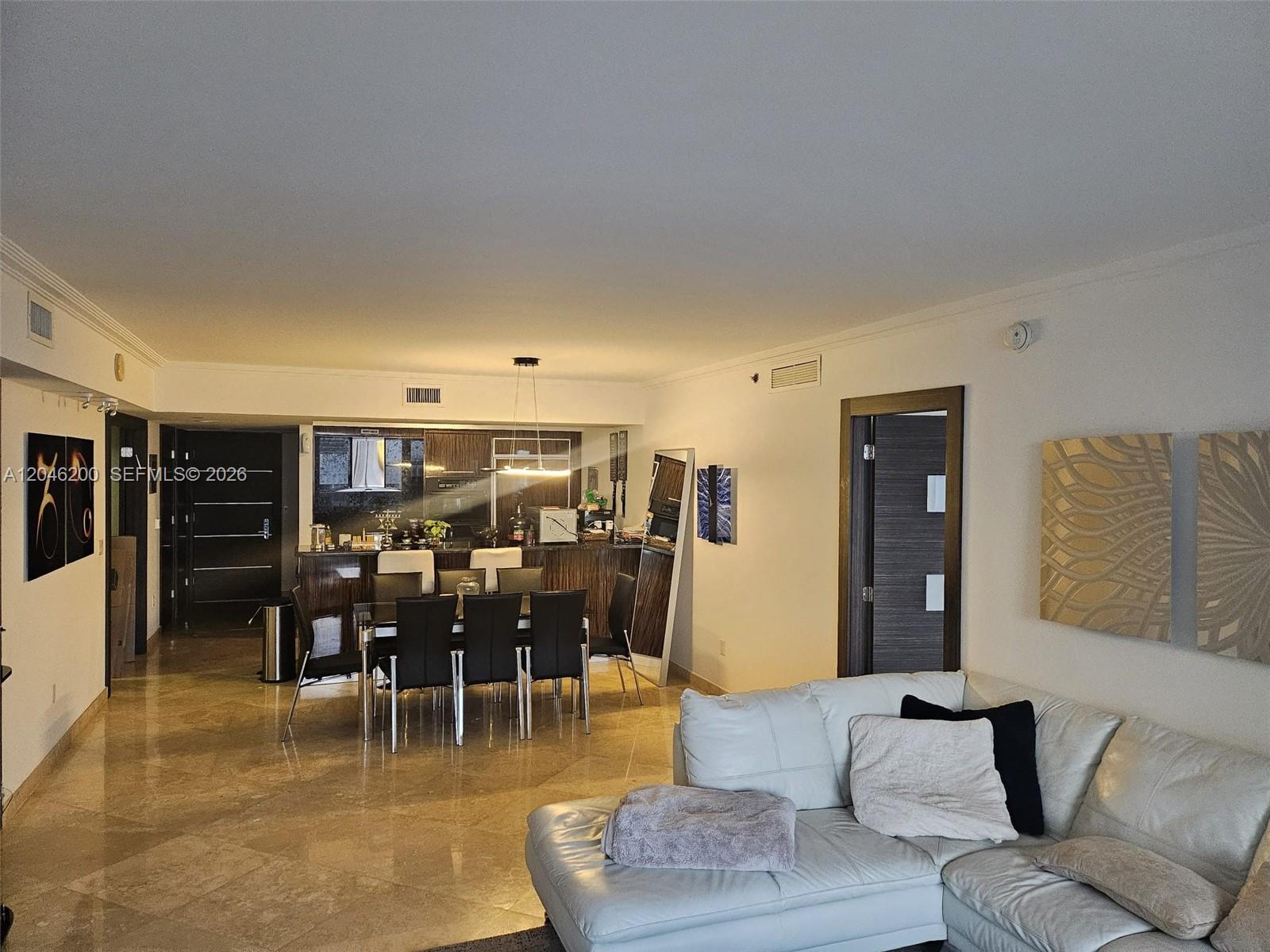 A living and dining area features white tile floors, a white sofa, and a kitchen — 1830 S Ocean Dr # 2403, Hallandale Beach FL 33009, HALLANDALE BEACH, FL